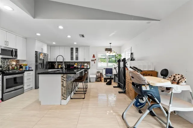 a kitchen with a table and chairs in it