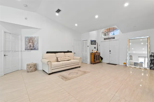 a living room with furniture and a large mirror