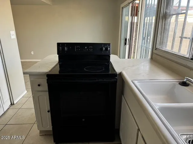 a view with cabinets a window and a counter space