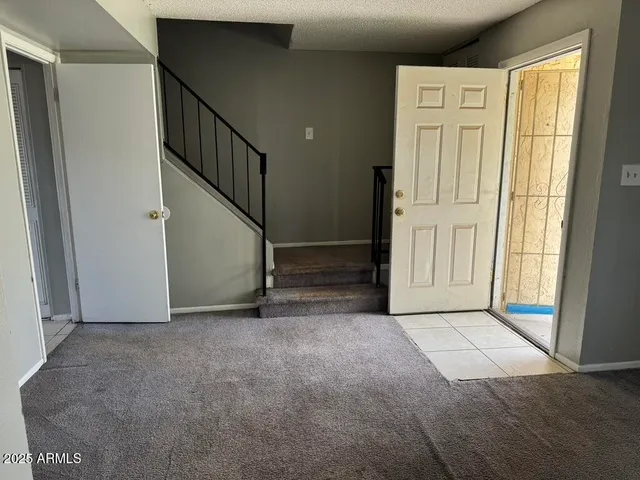 a view of an empty room with stairs