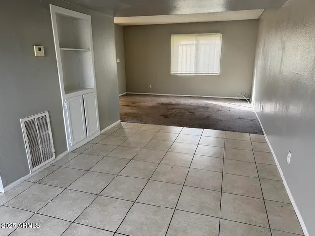 a kitchen with a stove top oven and cabinets
