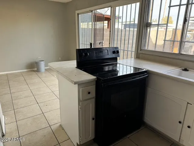 a view of a kitchen that has a sink and a stove