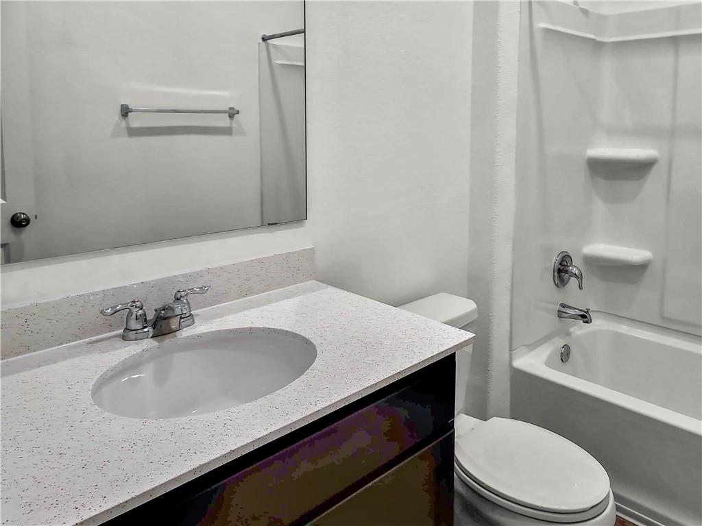 251 Geode Glen Maxwell, TX 78656 - Photo 11 of 16 a bathroom with a sink a toilet and bathtub