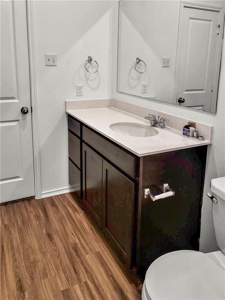251 Geode Glen Maxwell, TX 78656 - Photo 12 of 16 a bathroom with a sink mirror vanity and toilet
