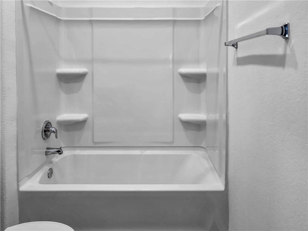 251 Geode Glen Maxwell, TX 78656 - Photo 15 of 16 a bathroom with a bathtub and shower