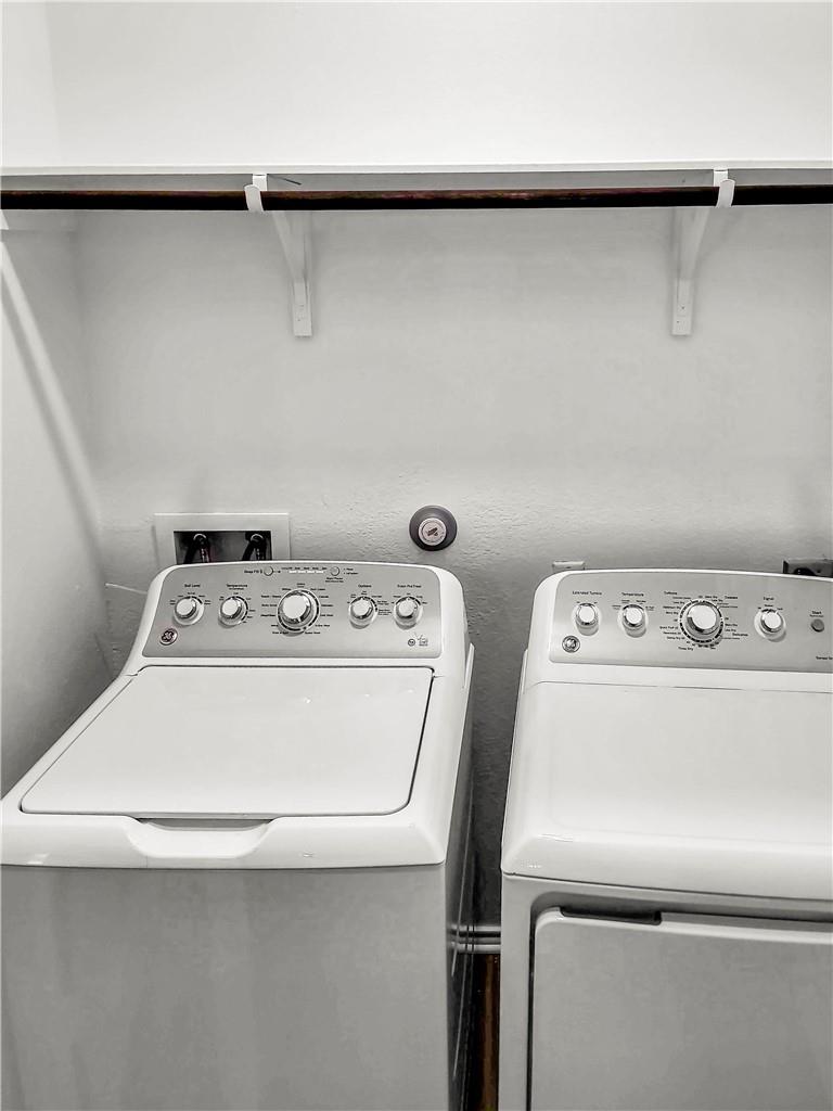 251 Geode Glen Maxwell, TX 78656 - Photo 16 of 16 a utility room with dryer and washer