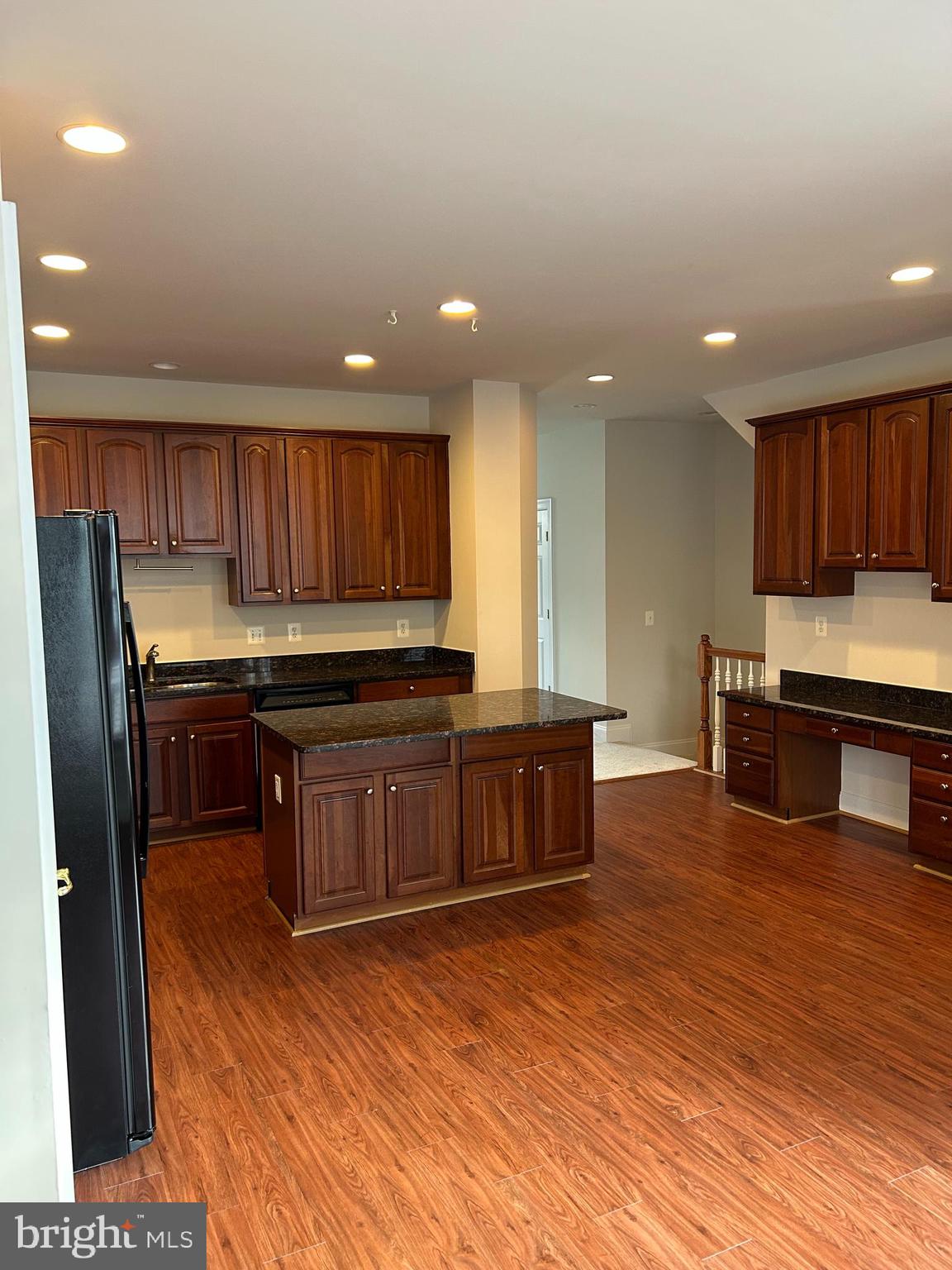 6872 Witton Circle Gainesville, VA 20155 - Photo 8 of 22 a kitchen with kitchen island granite countertop wooden cabinets a sink and dishwasher