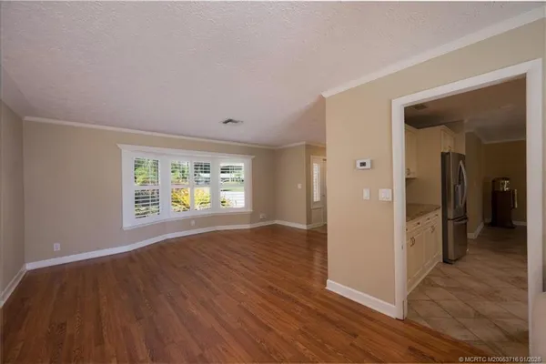 a open kitchen with kitchen island a sink window and a counter top space