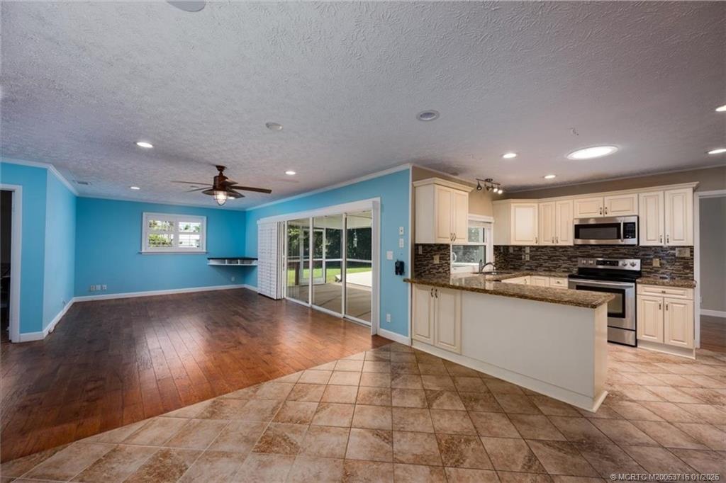 511 Krueger Parkway Stuart, FL 34996 - Photo 18 of 56 a open kitchen with kitchen island a sink window and a counter top space