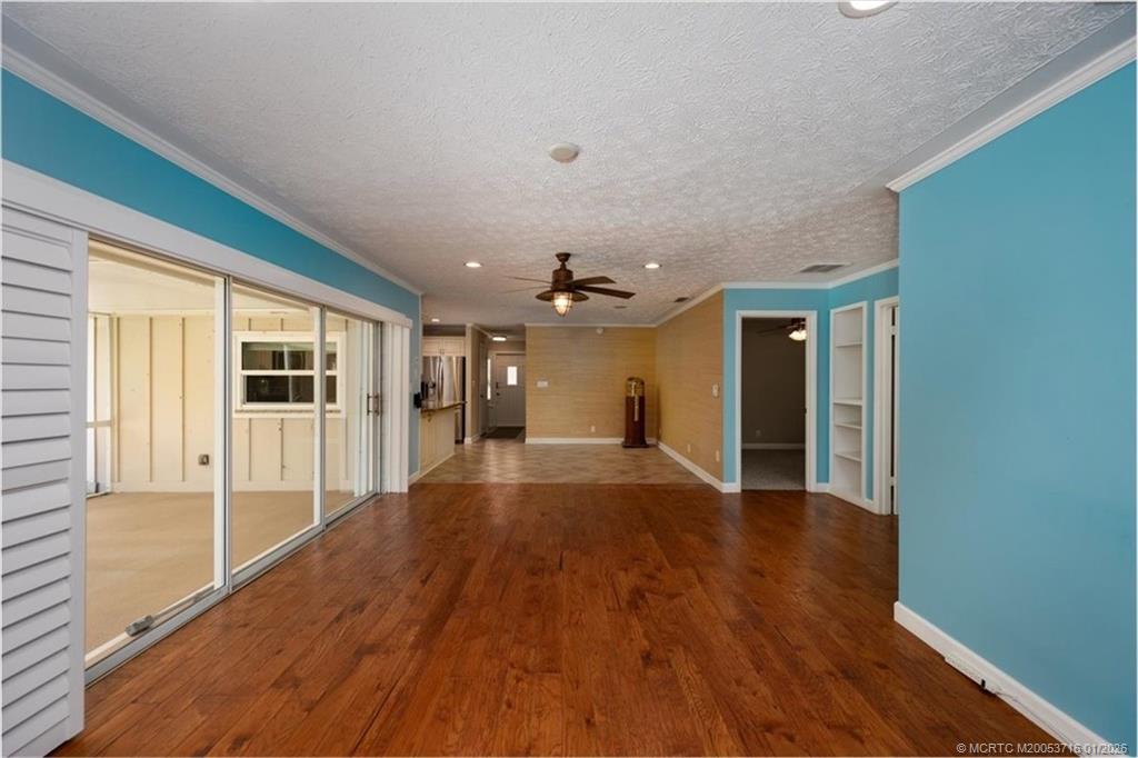 511 Krueger Parkway Stuart, FL 34996 - Photo 20 of 56 a view of an empty room with wooden floor and a window