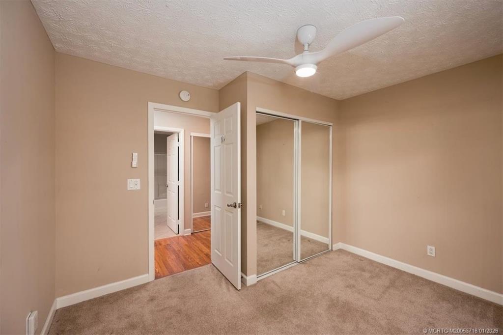 511 Krueger Parkway Stuart, FL 34996 - Photo 29 of 56 an empty room with closet and a ceiling fan