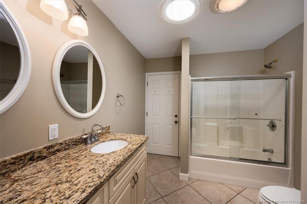 511 Krueger Parkway Stuart, FL 34996 - Photo 30 of 56 a bathroom with a granite countertop sink and a mirror