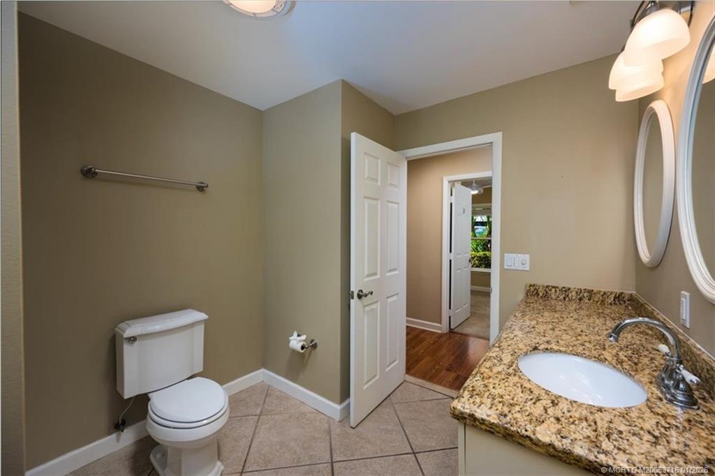 511 Krueger Parkway Stuart, FL 34996 - Photo 31 of 56 a bathroom with a granite countertop sink and a mirror