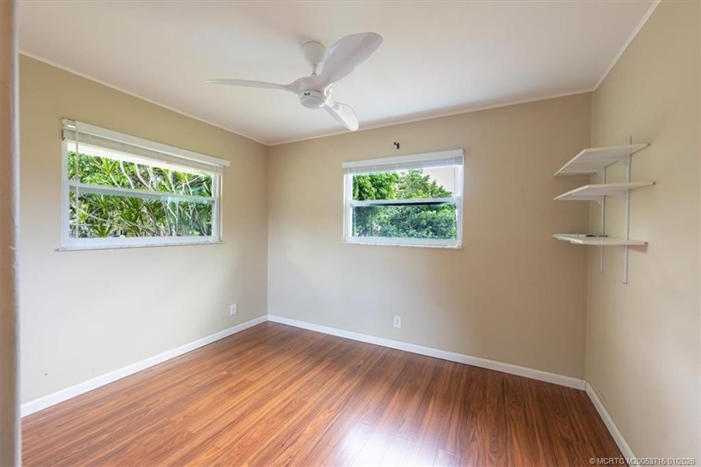 511 Krueger Parkway Stuart, FL 34996 - Photo 37 of 56 an empty room with wooden floor and windows