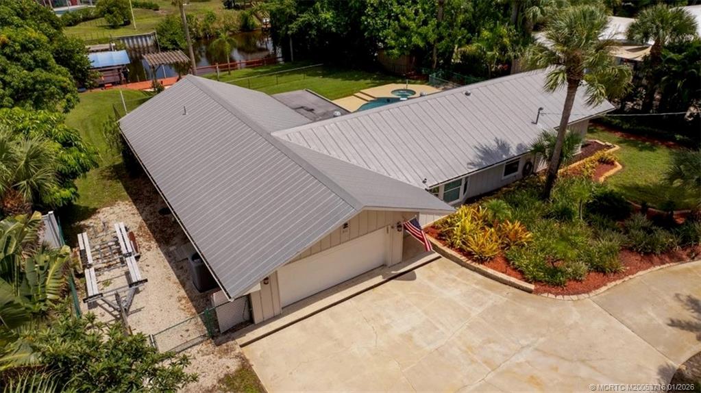511 Krueger Parkway Stuart, FL 34996 - Photo 4 of 56 an aerial view of a house with a yard and lake view