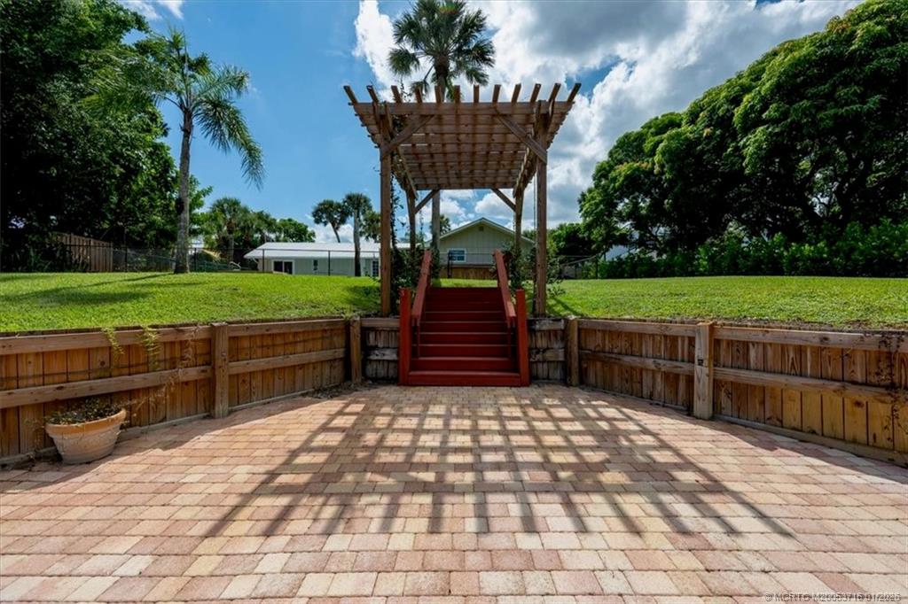 511 Krueger Parkway Stuart, FL 34996 - Photo 48 of 56 a view of a bench and chair in the garden