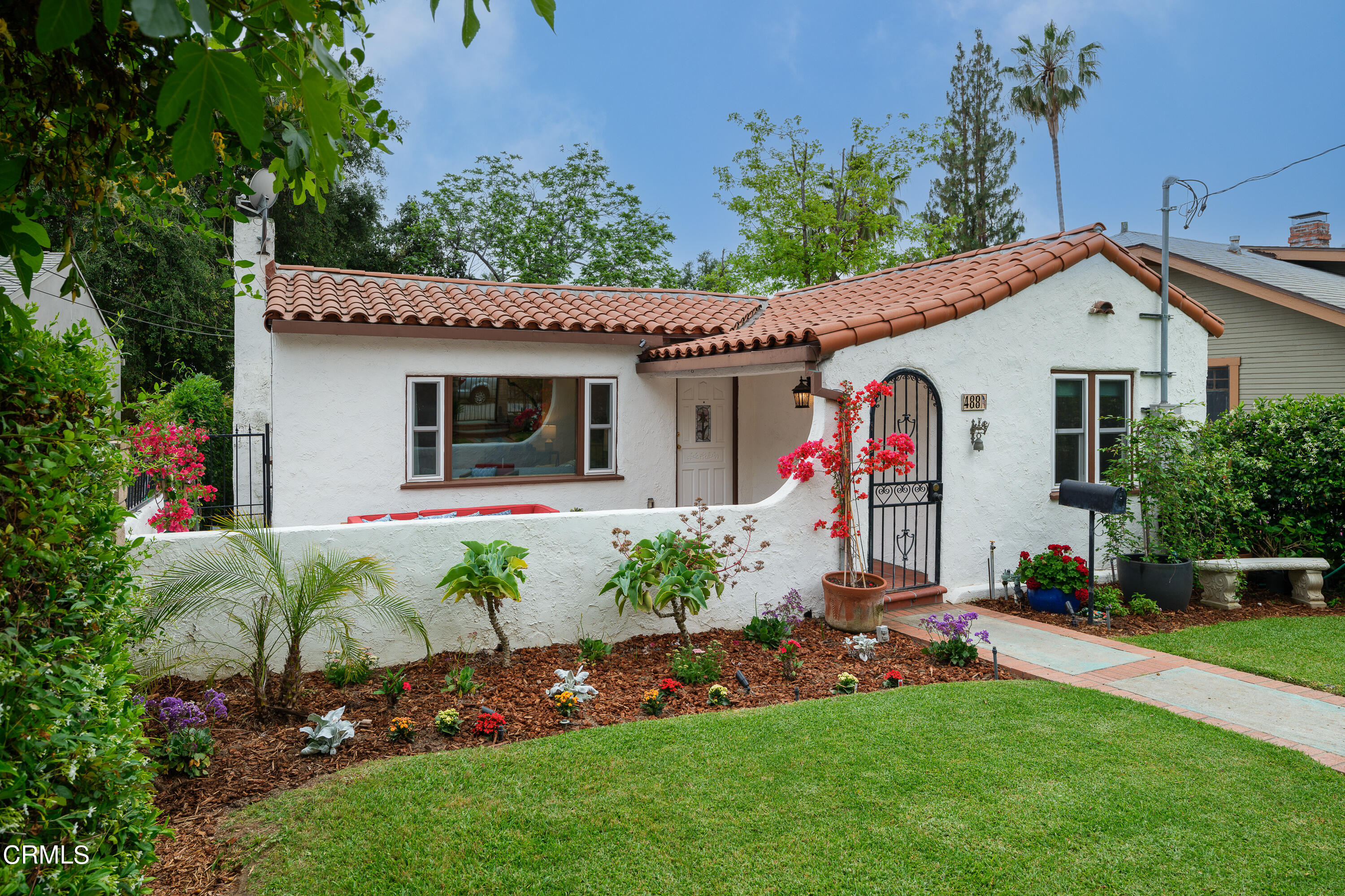 488 Colman Street Altadena, CA 91001 - Photo 5 of 75 a view of a white house with a big yard and potted plants