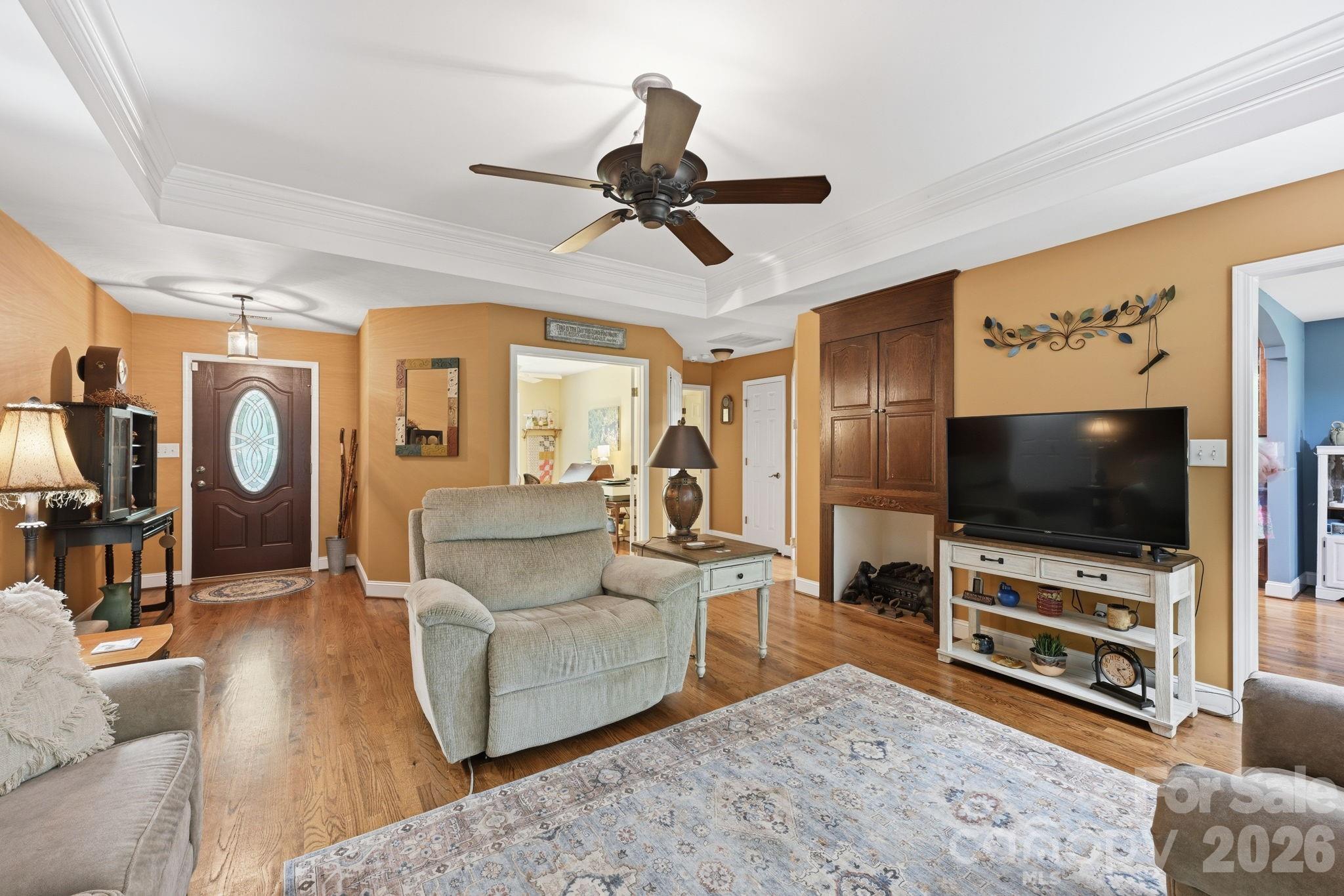 145 Upper Spencer Mountain Road Stanley, NC 28164 - Photo 7 of 29 a living room with furniture and a flat screen tv