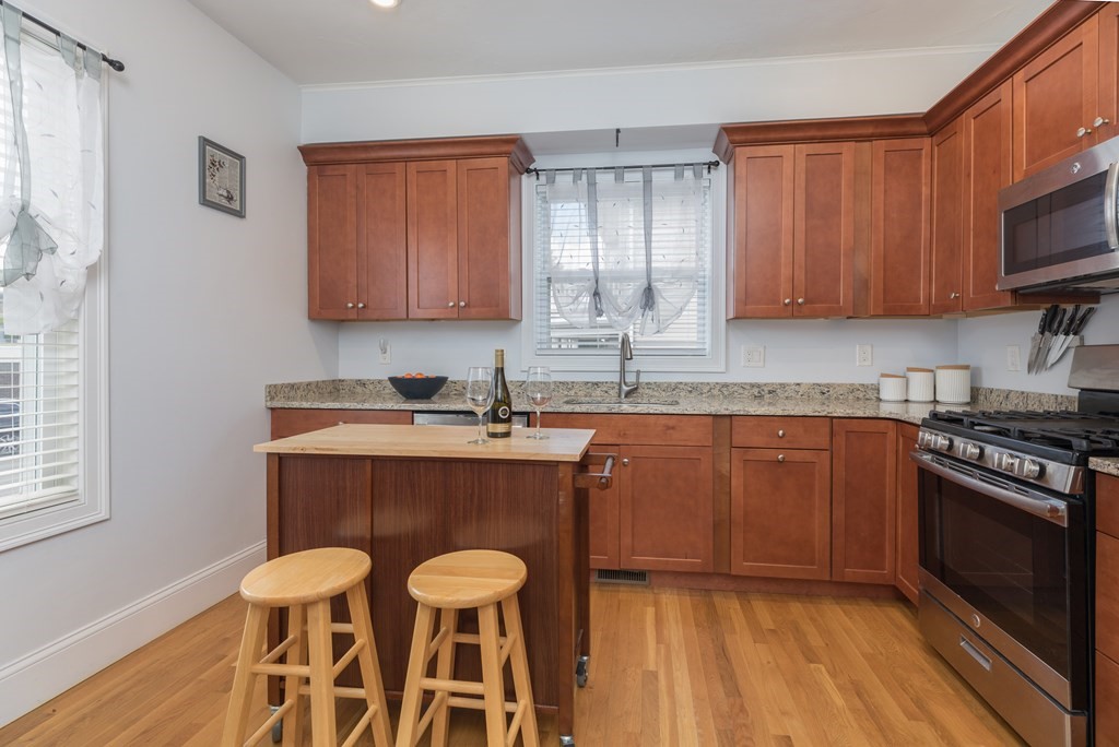 a kitchen with a sink cabinets and wooden floor