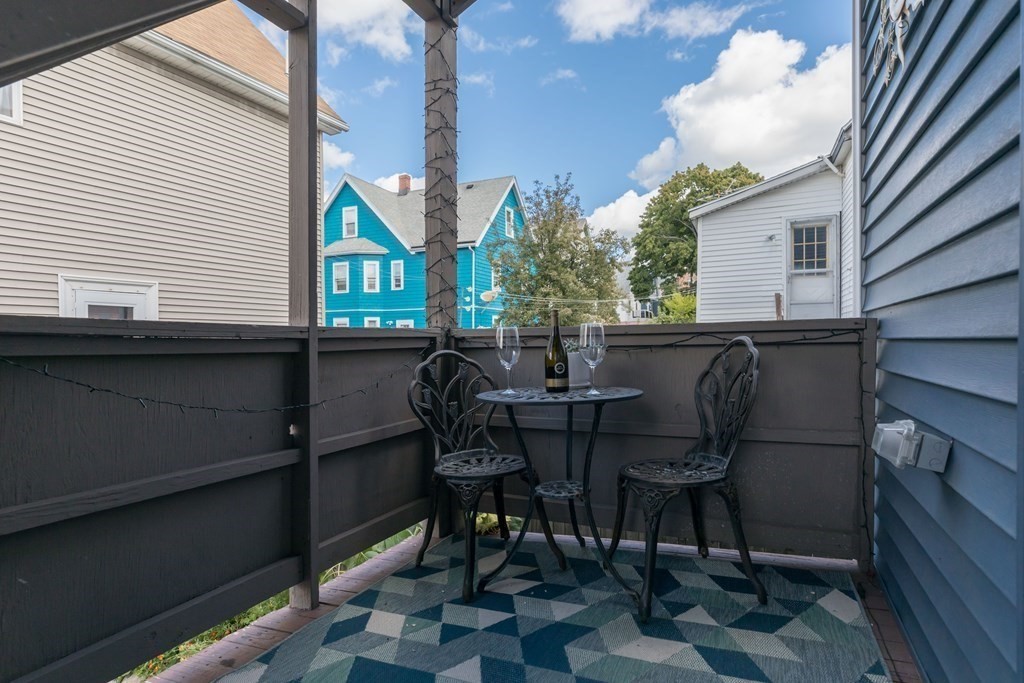 4 Cross Street, Unit 1 Malden, MA 02148 - Photo 14 of 17 a view of a patio with table and chairs and potted plants