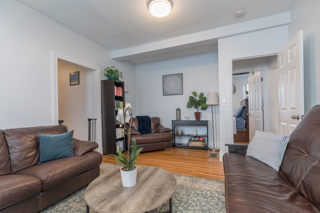 4 Cross Street, Unit 1 Malden, MA 02148 - Photo 6 of 17 a living room with furniture and a wooden floor