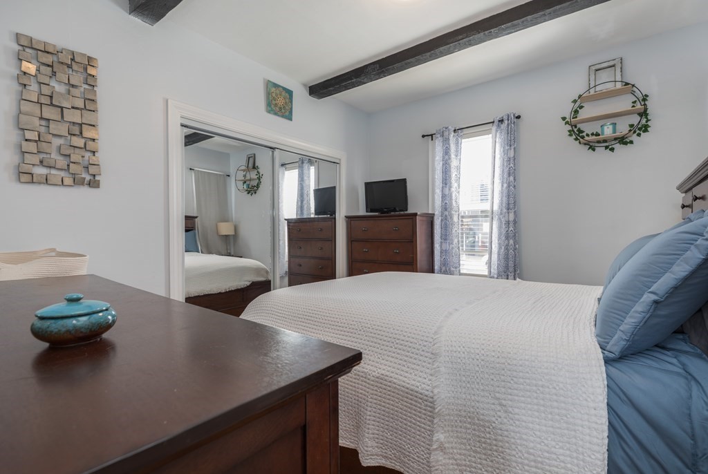 4 Cross Street, Unit 1 Malden, MA 02148 - Photo 7 of 17 a bedroom with a bed and a dresser