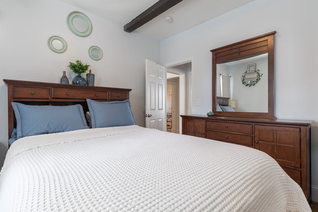 4 Cross Street, Unit 1 Malden, MA 02148 - Photo 8 of 17 a bedroom with a bed and painting on the wall