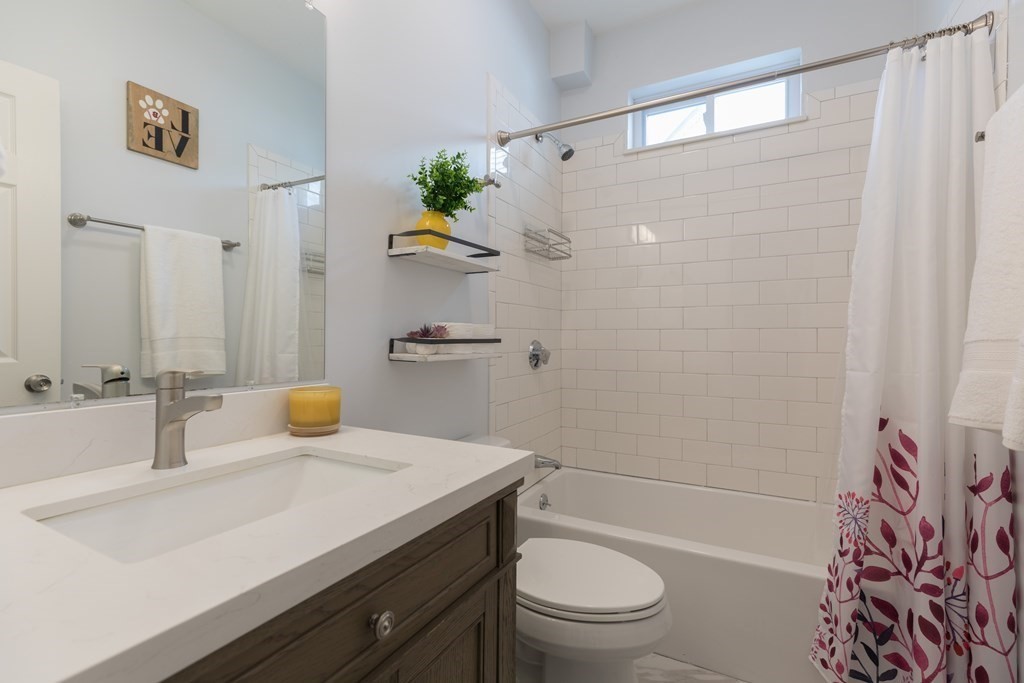 4 Cross Street, Unit 1 Malden, MA 02148 - Photo 9 of 17 a bathroom with a sink a toilet and shower