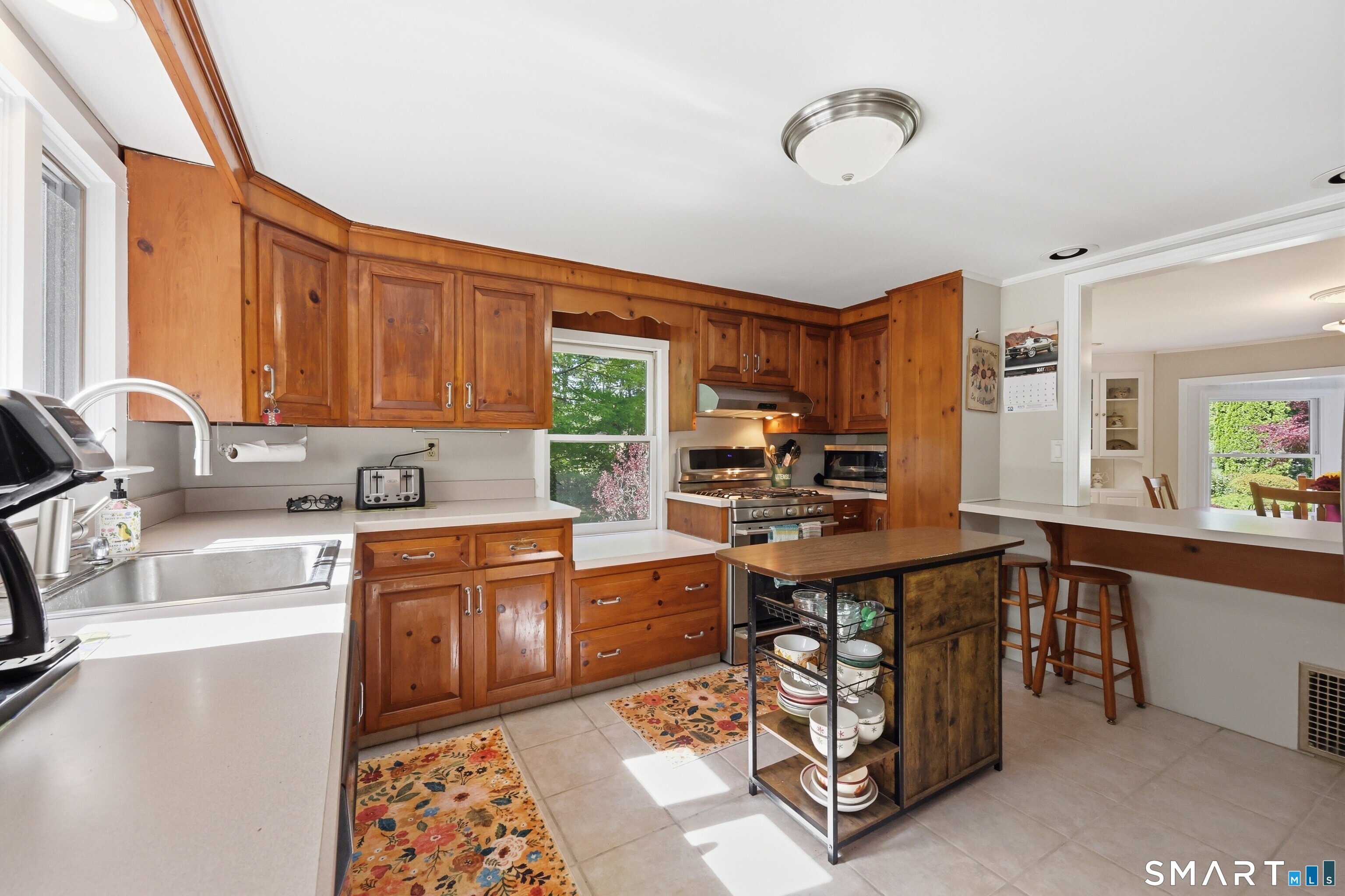 174 Canton Road Granby, CT 06035 - Photo 5 of 35 a kitchen with stainless steel appliances granite countertop a stove top oven a sink dishwasher and cabinets with wooden floor