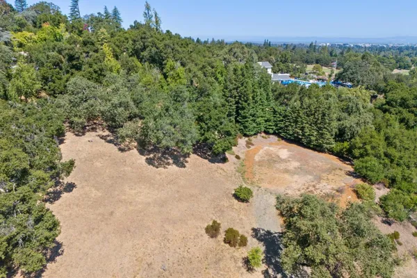 an aerial view of a houses with yard