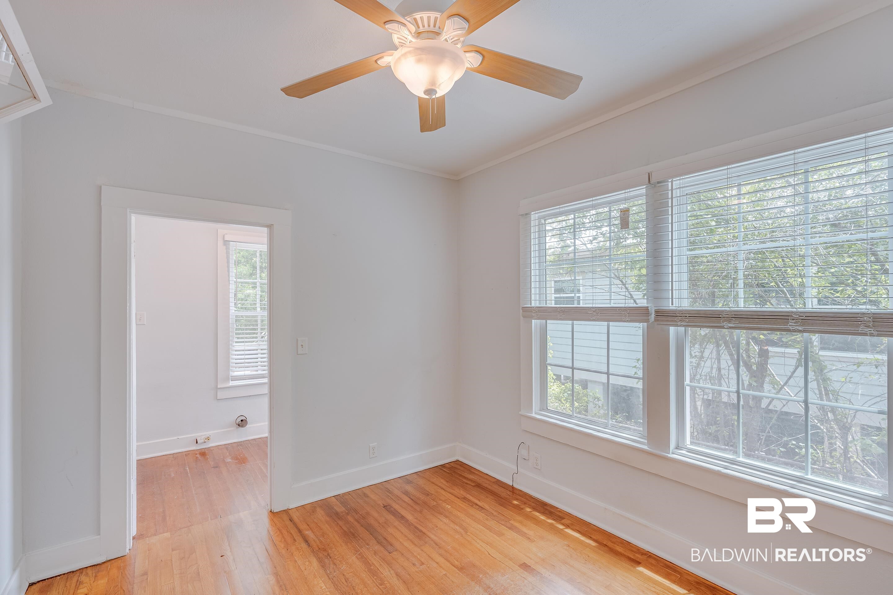 1852 Old Shell Road Mobile, AL 36607 - Photo 18 of 26 Unfurnished room featuring light wood-style floors, ornamental molding, and ceiling fan