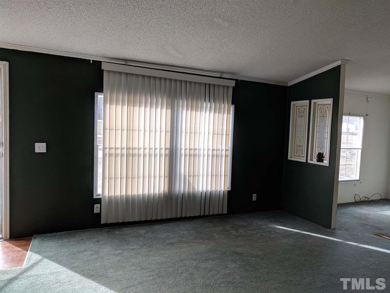 170 Beaver Dam Road Henderson, NC 27537 - Photo 3 of 8 an empty room with windows
