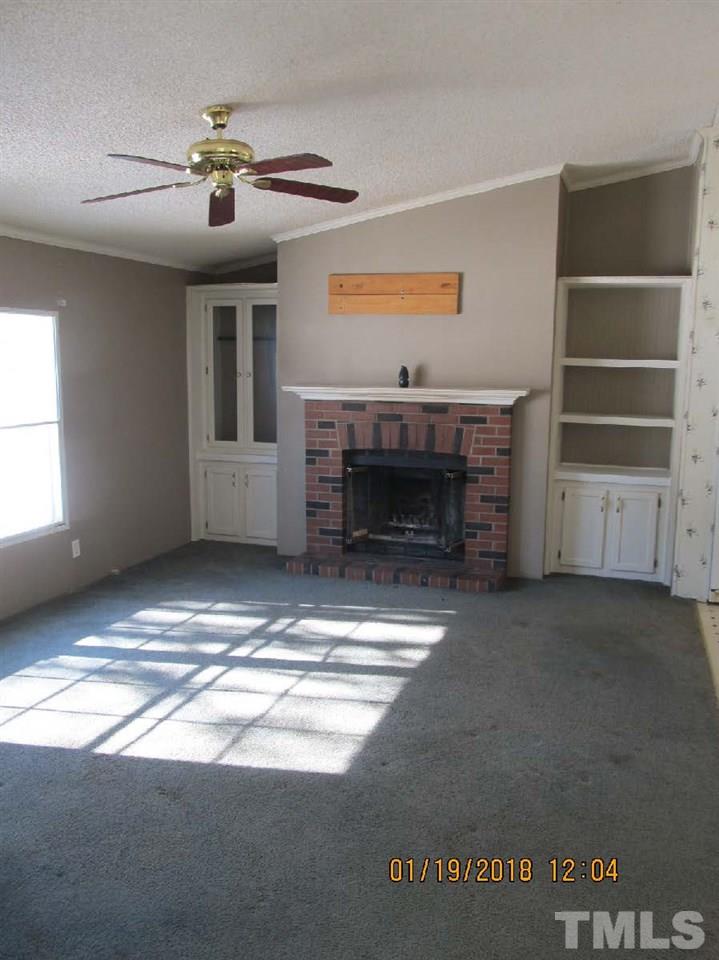 170 Beaver Dam Road Henderson, NC 27537 - Photo 5 of 8 a view of fireplace and a window