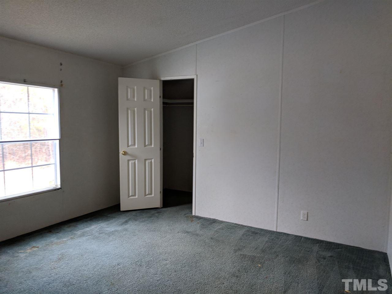 170 Beaver Dam Road Henderson, NC 27537 - Photo 7 of 8 an empty room with windows