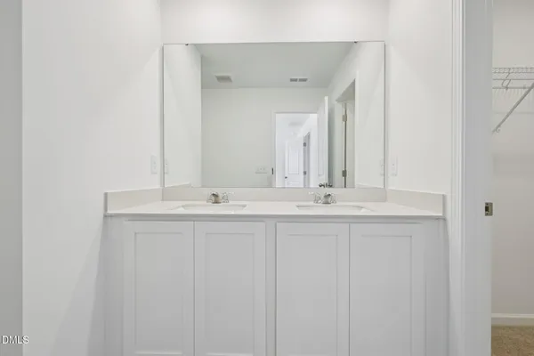 a bathroom with a glass shower door and mirror