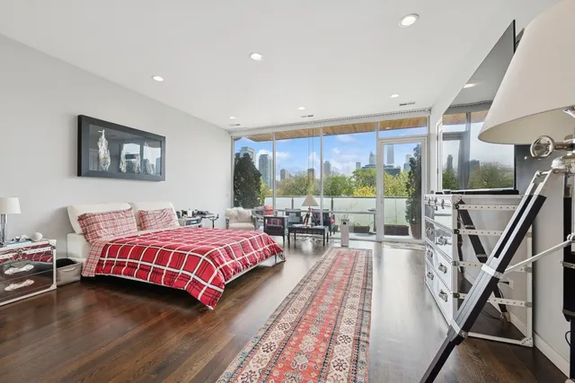 a living room with a bed furniture and a large window