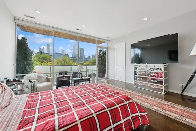 a bedroom with a bed and flat screen tv
