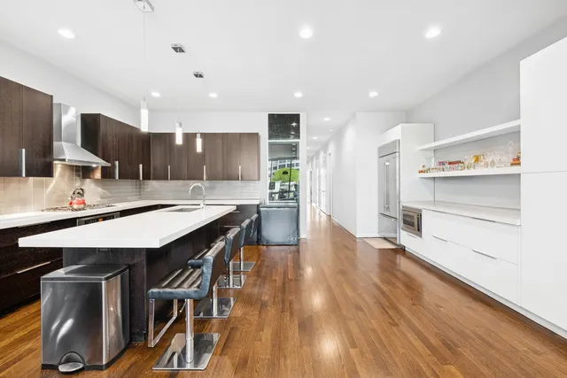 a large kitchen with a table and chairs