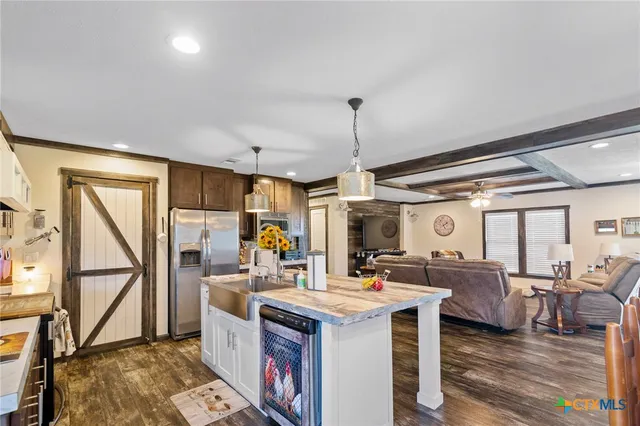 a kitchen with a table chairs refrigerator and cabinets