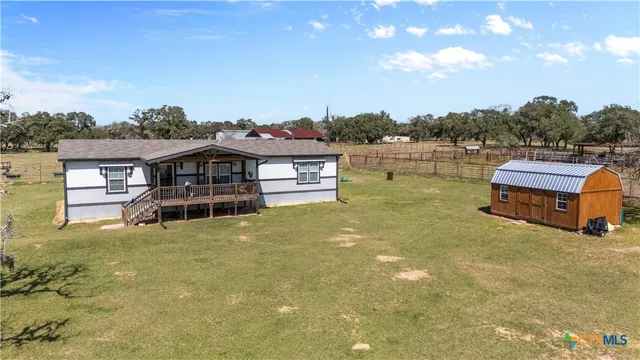 an aerial view of a house with a swimming pool