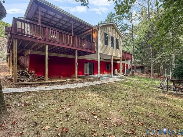 a view of a house with a yard and wooden floor and fence