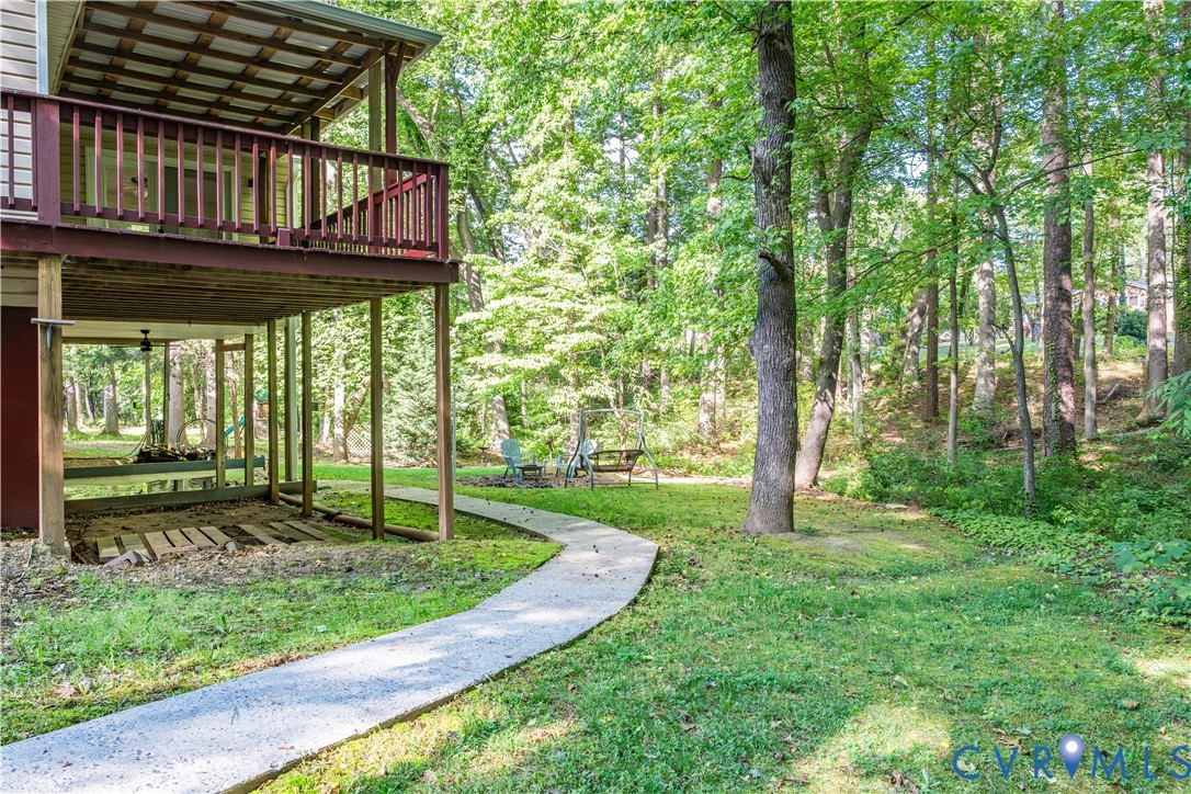 1024 Green Hill Road South Hill, VA 23970 - Photo 23 of 30 a view of a backyard with table and chairs and wooden fence
