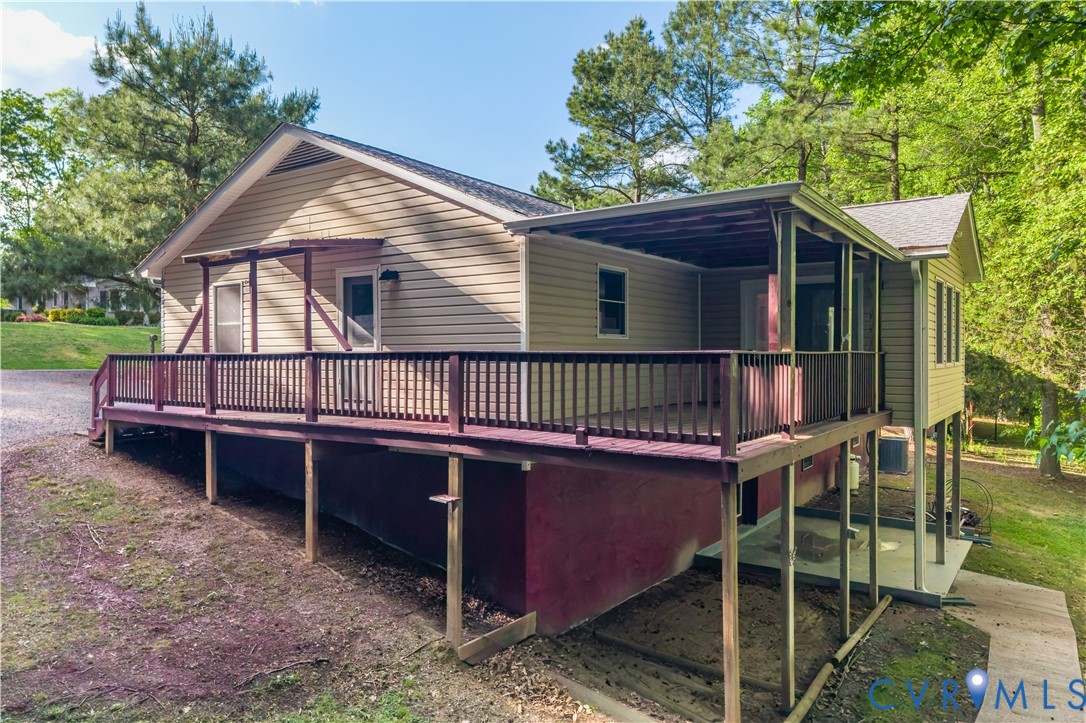 1024 Green Hill Road South Hill, VA 23970 - Photo 30 of 30 a backyard of a house with wooden deck and outdoor seating