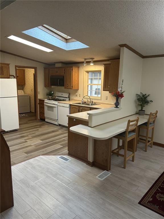 269 Ridge Lane Murrysville, PA 15668 - Photo 12 of 32 a kitchen with kitchen island a stove a sink dishwasher and a dining table with wooden floor