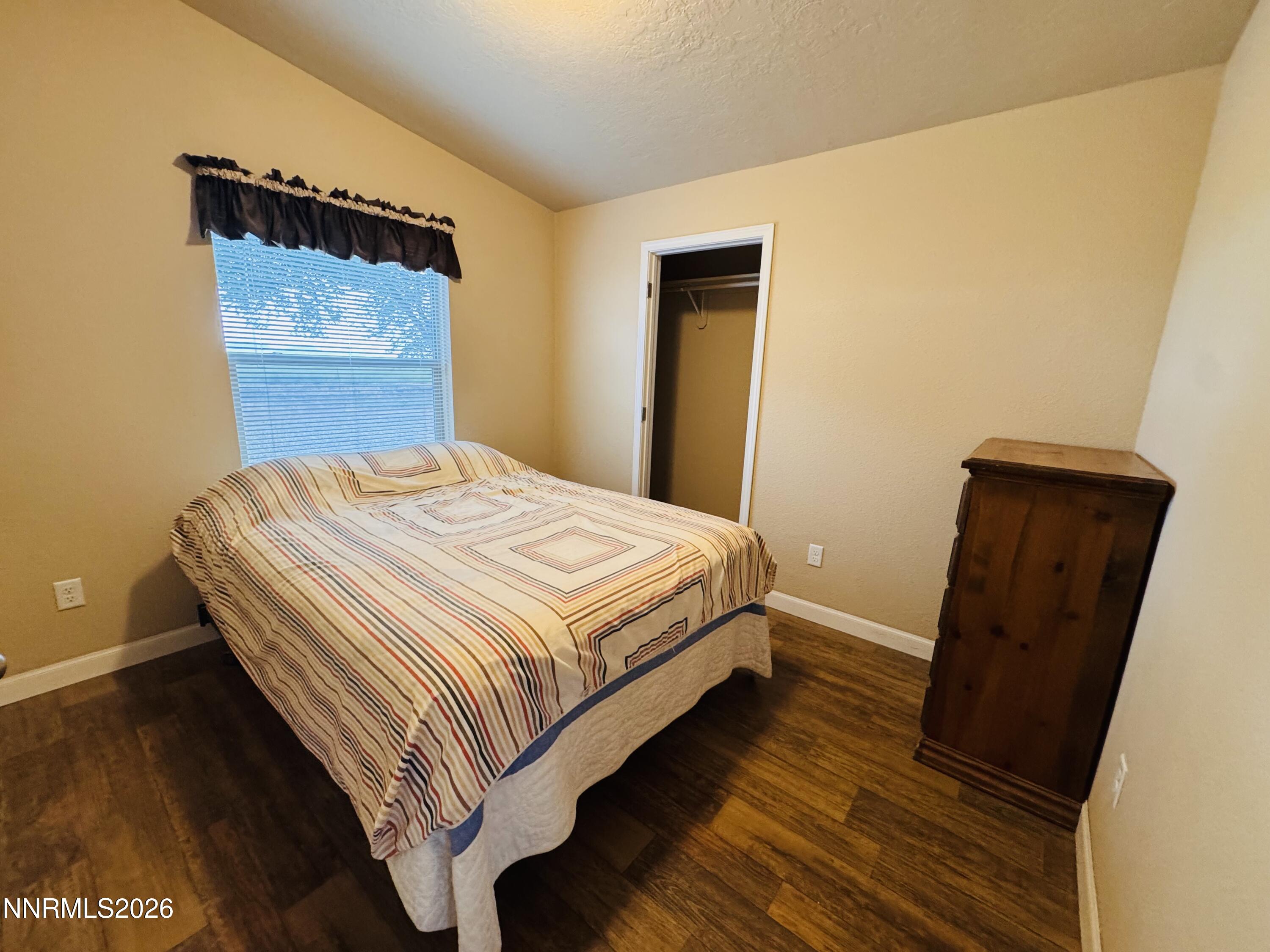29400 Kings River Road Orovada, NV 89425 - Photo 24 of 40 a bedroom with a bed and wooden floor
