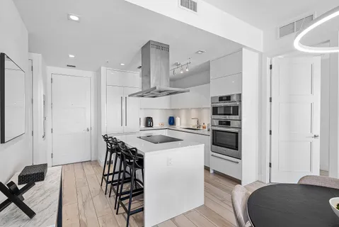 a kitchen with a stove a sink and a refrigerator