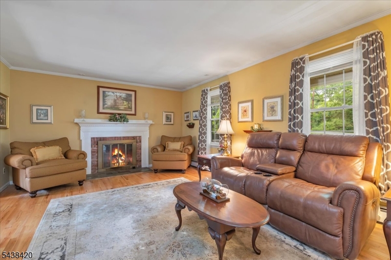 79 Main Street Califon, NJ 07830 - Photo 5 of 50 a living room with furniture a fireplace and a large window