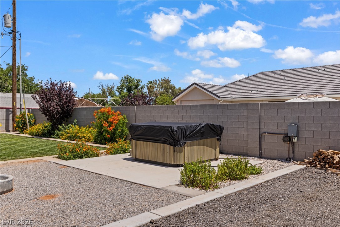 3020 Hannig Street Logandale, NV 89021 - Photo 70 of 75 An inviting backyard oasis offers a private spa and vibrant landscaping.