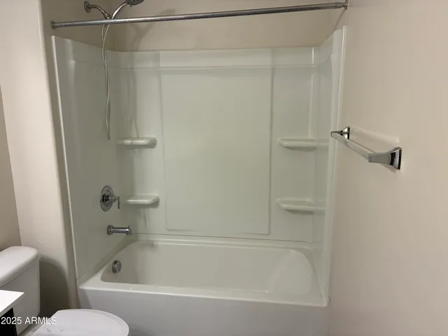 a bathroom with a bathtub and a toilet