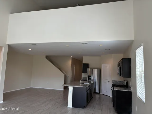 a view of a kitchen with furniture and wooden floor